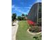 Beautiful landscaping with vibrant red flowers, lush green grass, and a stone pathway at 1501 Sunset Pointe Pl, Kissimmee, FL 34744