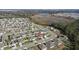 Aerial view of a house and surrounding neighborhood, near a lake at 15335 White Tail Loop, Mascotte, FL 34753