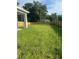 Large grassy backyard with wooden privacy fence at 1810 Dunbar St, Bartow, FL 33830