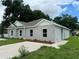 Newly constructed home with gray exterior, landscaped yard, and driveway at 1810 Dunbar St, Bartow, FL 33830