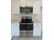 Modern kitchen with stainless steel appliances and white cabinets at 1810 Dunbar St, Bartow, FL 33830