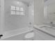 Renovated bathroom featuring a white vanity, marble shower, and soaking tub at 1812 Corolla Ct, Deltona, FL 32738