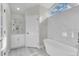 Bathroom with white vanity, freestanding tub, and marble shower surround at 1812 Corolla Ct, Deltona, FL 32738