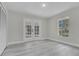 Bedroom with french doors opening to a patio, and a window at 1812 Corolla Ct, Deltona, FL 32738