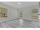 Bedroom with large windows, grey vinyl plank flooring, and neutral wall colors at 1812 Corolla Ct, Deltona, FL 32738