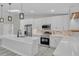 Modern kitchen with white cabinets, quartz countertops, and stainless steel appliances at 1812 Corolla Ct, Deltona, FL 32738