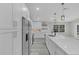 Modern kitchen with white cabinets, quartz countertops and stainless steel appliances at 1812 Corolla Ct, Deltona, FL 32738