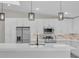 Modern kitchen with white cabinets, quartz countertops and stainless steel appliances at 1812 Corolla Ct, Deltona, FL 32738