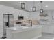 Modern kitchen with white cabinets, quartz countertops and stainless steel appliances at 1812 Corolla Ct, Deltona, FL 32738