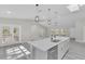 Open concept kitchen with island, white cabinets, and stainless steel appliances at 1812 Corolla Ct, Deltona, FL 32738