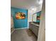 Bright and stylish bathroom with a double sink vanity, a granite countertop, and unique tropical wall art at 2459 Taloncrest Ct, Eagle Lake, FL 33839