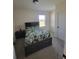 Cozy bedroom with a full-sized bed, neutral walls, and a window that offers a view to the outdoors at 2459 Taloncrest Ct, Eagle Lake, FL 33839