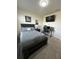 Modern bedroom featuring neutral carpet, a cozy bed, and a desk area perfect for work or study at 2459 Taloncrest Ct, Eagle Lake, FL 33839