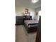 Comfortable bedroom with a full-sized bed, dresser, and decor for a modern and stylish look at 2459 Taloncrest Ct, Eagle Lake, FL 33839