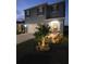 Charming two-story home with landscaped yard, walkway, and lit up palm tree at 2459 Taloncrest Ct, Eagle Lake, FL 33839