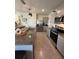 Well-lit kitchen featuring stainless steel appliances, granite countertops, and a double sink at 2459 Taloncrest Ct, Eagle Lake, FL 33839