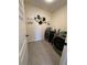 Efficient laundry room with tile floors, modern washer and dryer, and decorative wall art at 2459 Taloncrest Ct, Eagle Lake, FL 33839