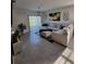 Bright living room with a large sectional sofa, stylish decor, and sliding glass door to backyard at 2459 Taloncrest Ct, Eagle Lake, FL 33839