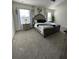 Spacious main bedroom featuring neutral carpeting, ample natural light, and elegant decor creating a relaxing retreat at 2459 Taloncrest Ct, Eagle Lake, FL 33839