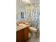 Clean bathroom with shower/tub combo, updated vanity, and beach-themed decor at 2645 Oneida Loop, Kissimmee, FL 34747