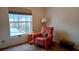 Relaxing bedroom with chair and side table, flooded with natural light and pool view at 2645 Oneida Loop, Kissimmee, FL 34747