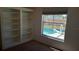 Bedroom with built-in shelving and window view of the inviting private pool at 2645 Oneida Loop, Kissimmee, FL 34747