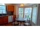 Bright breakfast nook featuring a round table with four chairs, kitchen cabinets, and bright windows at 2645 Oneida Loop, Kissimmee, FL 34747