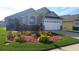 Charming home featuring a well-manicured lawn, flower beds and a two car garage at 2645 Oneida Loop, Kissimmee, FL 34747