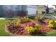 Well-maintained front yard with a unique floral arrangement and landscaping at 2645 Oneida Loop, Kissimmee, FL 34747