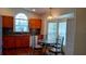 Kitchen with laminate flooring, warm tone cabinets, and a breakfast nook near the windows at 2645 Oneida Loop, Kissimmee, FL 34747