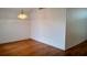 An empty living room featuring laminate flooring with a view of other rooms in the house at 2645 Oneida Loop, Kissimmee, FL 34747