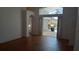 Living room with wood floors and sliding door access to the outdoor patio and pool at 2645 Oneida Loop, Kissimmee, FL 34747