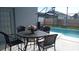 Relaxing patio with table and chairs, perfect for enjoying the poolside view at 2645 Oneida Loop, Kissimmee, FL 34747
