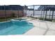 Sparkling in-ground pool and spa area with a screened enclosure and comfortable seating at 2645 Oneida Loop, Kissimmee, FL 34747