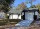 Recently painted house with a landscaped yard and driveway at 2948 Willow Bend Blvd, Orlando, FL 32808