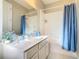 Bathroom with a shower/tub combo, vanity, and blue accents at 304 Sorrento Road, Poinciana, FL 34759