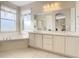 Double vanity bathroom with soaking tub at 304 Sorrento Road, Poinciana, FL 34759