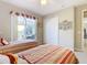 Bedroom with two twin beds and access to a private patio at 304 Sorrento Road, Poinciana, FL 34759