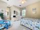 Bedroom with full bed and access to a shared bathroom at 304 Sorrento Road, Poinciana, FL 34759
