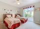 Two twin beds in a well-lit bedroom with patio access at 304 Sorrento Road, Poinciana, FL 34759