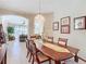 Formal dining room with wooden table and chandelier at 304 Sorrento Road, Poinciana, FL 34759