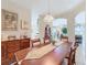 Elegant dining room with a wooden table and access to living room at 304 Sorrento Road, Poinciana, FL 34759