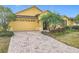 Landscaped front yard with brick driveway at 304 Sorrento Road, Poinciana, FL 34759