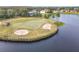Golf course green with sand traps and lake at 304 Sorrento Road, Poinciana, FL 34759