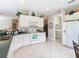 Well-equipped kitchen with white cabinets and modern appliances at 304 Sorrento Road, Poinciana, FL 34759