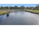 Serene lake view with a wooden bridge at 304 Sorrento Road, Poinciana, FL 34759