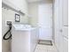 Bright laundry room with washer, dryer, and ample shelving at 304 Sorrento Road, Poinciana, FL 34759