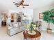 Bright living room with comfy sofas and a view into dining area at 304 Sorrento Road, Poinciana, FL 34759