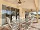 Covered patio with seating area and ceiling fans at 304 Sorrento Road, Poinciana, FL 34759