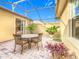 Covered patio with seating area, perfect for outdoor dining and relaxation at 304 Sorrento Road, Poinciana, FL 34759